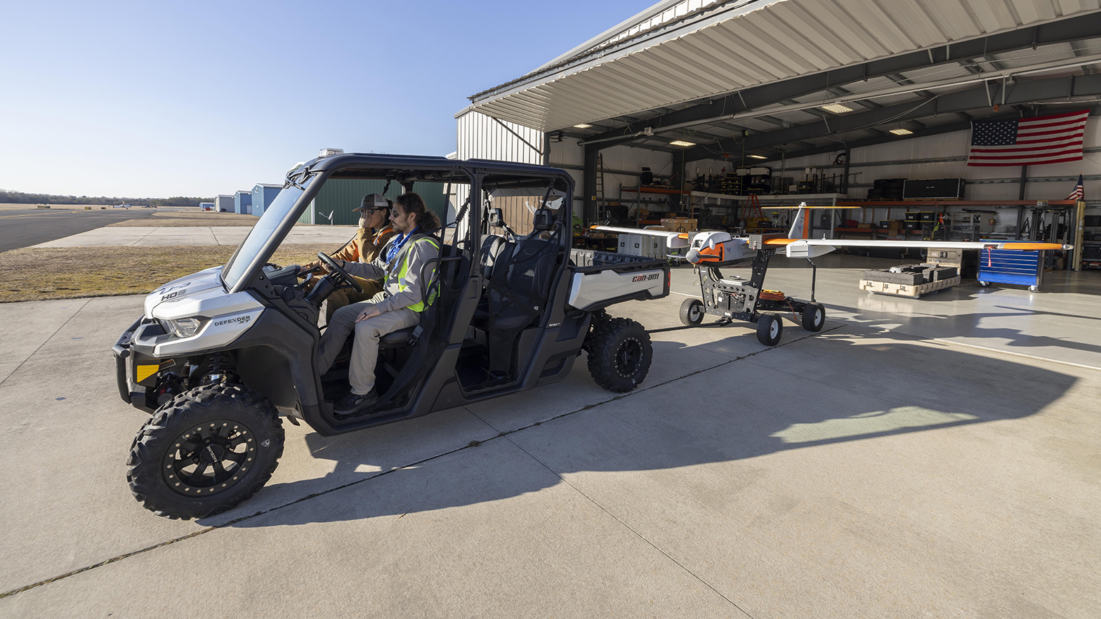 Hovig Yaralian, Flight Operations Manager and Brennan Scheffler, Flight Test Engineer, tow the UAS to the launch site
